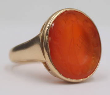 JEWELRY. 14kt Gold and Antique Carnelian Intaglio: Ring. 14kt yellow gold ring displaying a central bezel set oval antique carved carnelian intaglio of a familial crest. Per consignor provenance the carved carnelian intaglio displays a French familial