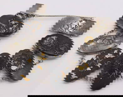 JEWELRY. Japanese Mixed Metal Shakudo Bracelet.: Japanese Shakudo bracelet comprised of (6) silver mounted mixed metal pendants displaying various scenes of flowers, figures and shrimp. With a silver clasp displaying a mixed metal depiction of a cro