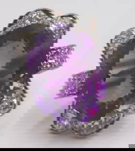 JEWELRY. Platinum Amethyst and Diamond Ring.: Platinum ring displaying a central prong-set oval faceted amethyst flanked by high shoulders inlaid with a total of (8) single cut diamonds, and further accented by a total of (14) round brilliant cut