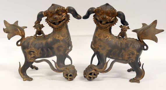 Pair of Japanese Gilt Metal Foo Lions.: Pair of Japanese gilt metal foo dogs with pups upon their backs and an openwork ball beneath one paw. From a Bedford, NY estate. Dimensions: foo dogs measure approx. 12.25" high.