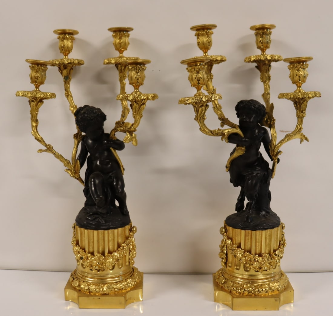 Fine Quality Gilt & Patinated Bronze Figural: Candelabra. Good large size with Cherubs (1 with hoof feet ) holding candelabra atop a fluted gilt bronze base adorned with swags. From a Westchester NY estate. - Dimensions: 22" x 12"