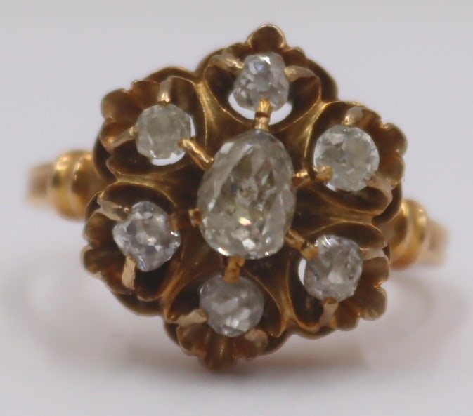 JEWELRY. Old Mine Cut Diamond and 14kt Gold Ring.: 14kt yellow gold and Old Mine cut diamond ring displaying a circular pendant accented by a central prong-set pear old mine cut diamond surrounded by (6) additional prong-set old mine cut diamonds. Sta