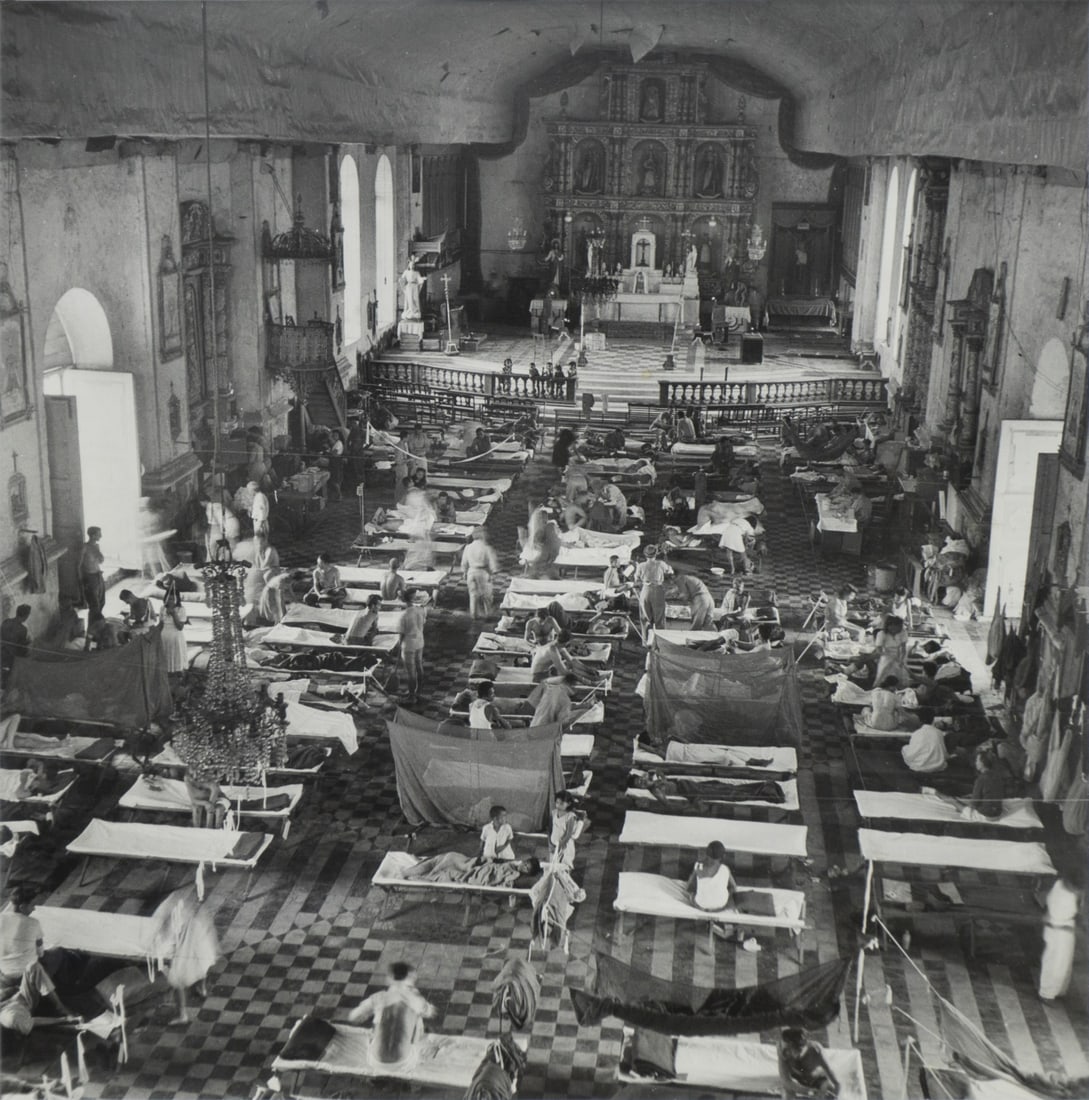 W. EUGENE SMITH (AMERICAN, 1918-1978).: 'American Hospital in Leyte Cathedral', 1944. Gelatin Silver Print. Verso: Stamped 'Life Photo by W. Eugene Smith', 'DEC 12 1944', 'FURCELL BOOK', '16584'. Inscribed 'Cathedral turned into Hospice / I