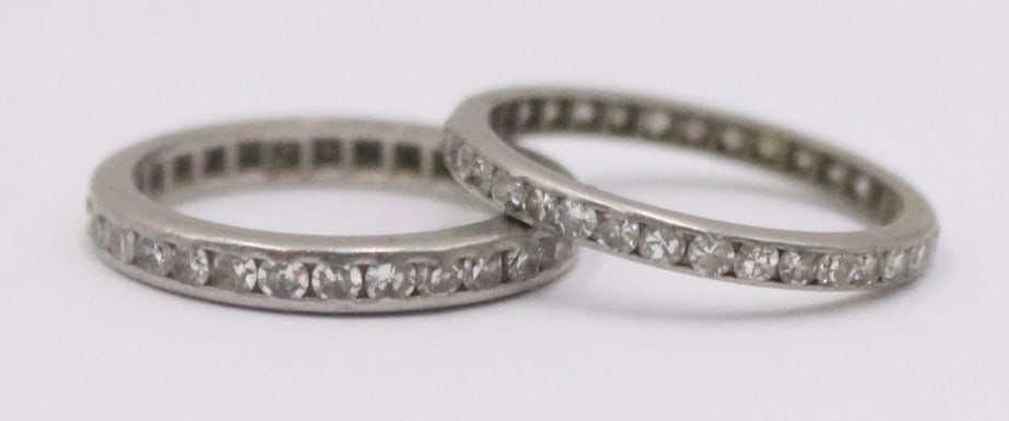 JEWELRY. (2) Platinum and Diamond Eternity Bands.: Includes (1) platinum and single cut diamond eternity band - band measures approx. 0.10" in width, ring size - 5 1/2. Accompanied by a platinum and single cut diamond eternity band - band measure