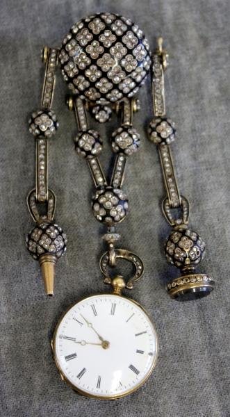 Marret & Baugrand Diamond and Enamel Chatelaine: and Watch. The gold chatelaine designed as a belt is set with diamonds, and suspends two chains, the first capped by a watch key, the other by a seal, and a fob watch. Case back is inscribed "F De S.M