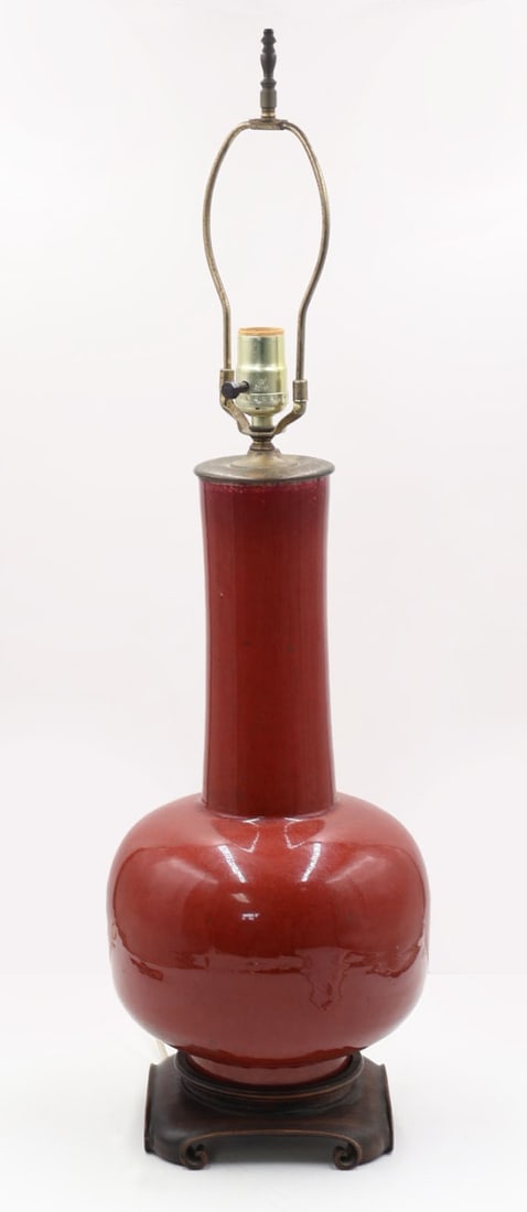 Chinese Sang de Beouf Vase as a Lamp.: Chinese Sang de Beouf vase mounted as a lamp on a carved wood base. From a New Fairfield, CT estate. Dimensions: vase only measures approx. 16" h excluding the base and hardware.