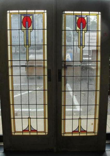 Pair of Leaded Glass Doors.: In the style of Frank Lloyd Wright. Leaded glass work in wooden framed doors. From a NJ estate where they have been stored for 30 years. Dimensions: 28" wide x 76" high.