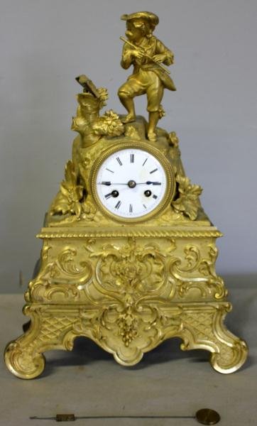 19th Century French Gilt Bronze Clock.: With musician surmount. Nice, original gilding. From a Greenwich, CT estate. Dimensions: 10.25" wide x 15" high.