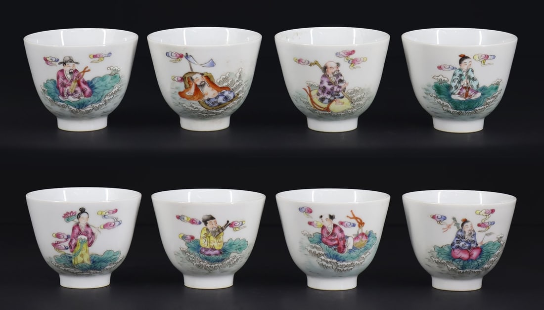 (8) Chinese Famille Rose Immortals Cups.: A set of eight footed Chinese Wanyu cups depicting the Eight Immortals atop lotus pads amongst multicolored clouds with their respective symbols to the opposite side of the cups. Base bears a two char