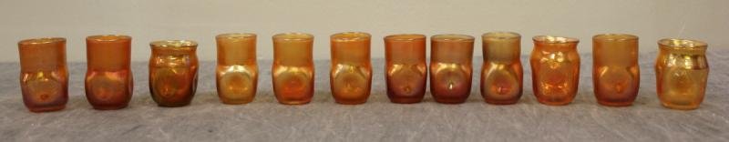 Misc. Group of 12 L.C. Tiffany Shot? Glasses.: With pinched square bases. Marked "L.C.T." and "T 27 ??" From the estate of an employee at L.C.T. Dimensions: Range from 1.75" to 2" high.