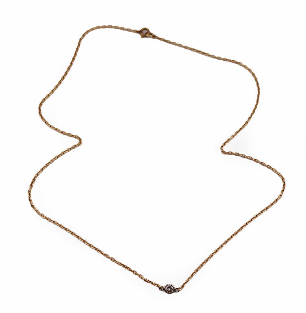JEWELRY. Petite 14kt Gold and Diamond Necklace.: Petite 14kt yellow gold chain link necklace displaying a central 12kt white gold mounted solitaire round brilliant cut diamond. Diamond measures approx. 3.0mm. Stamped, "14K". Total approx. 