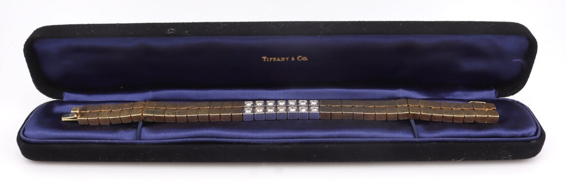 JEWELRY. Tiffany & Co. 18kt Gold and Diamond: Bracelet. Tiffany & Co. 18kt yellow gold double stacked row of articulated square form pendants with rounded shoulders. Central (14) 18kt white gold pendant displaying a total of (14) round full c