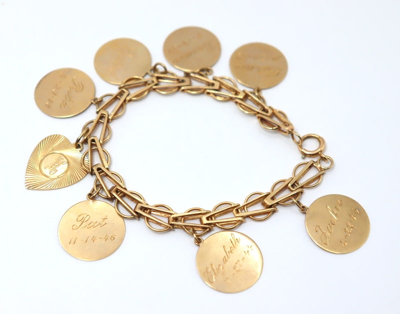 JEWELRY. Gold Bracelet with (8) 14kt Gold Charms.: An unmarked 13kt yellow gold bracelet spending (8) engraved charms - each charm stamped, "14K". Total approx. combined weight of the (8) charms and bracelet is 11.8 dwt (gross). From a Pelha