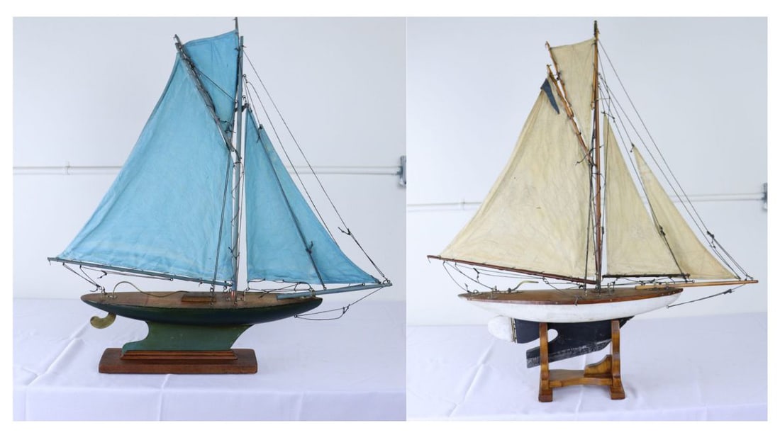 (2) English Models of Sailboats.: Includes a charming vintage model yacht with sails made from old blue sail cloth and original brass accents. Stand is recent to hold the ship upright and stabile. Measurements include the stand. Dimen