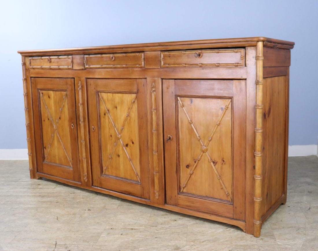 French Faux Bamboo Three Door Pine Enfilade.: A three door enfilade or buffet with three compartments and a non-adjustable interior shelf. All three doors lock with the original key. The bamboo trim and mouldings are charming, and give this piece