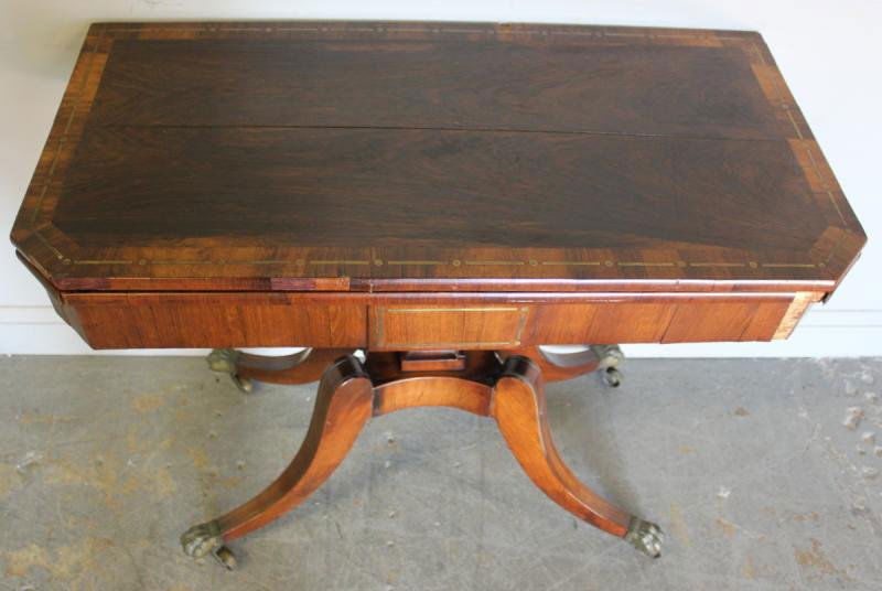 English Regency Rosewood and Mahogany Brass: Inlaid Saber Leg Card Table. With tooled leather top. From a Park Avenue, Manhattan estate. Dimensions: 36" wide x 17.75" deep x 30.25" high, Open - 35.75" wide x 36" deep. Condition: Original, as fou