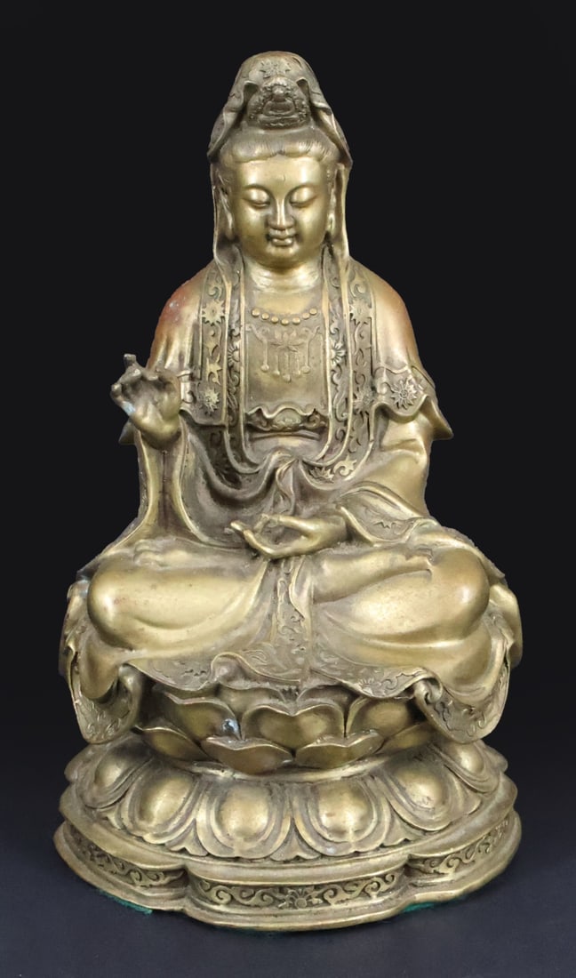 Seated Bronze Guanyin Sculpture.: A bronze sculpture of Guanyin seated atop a double lotus base. Apparently unmarked. From a Hopatcong, NJ estate. Dimensions: measures approx. 9.9" in height.