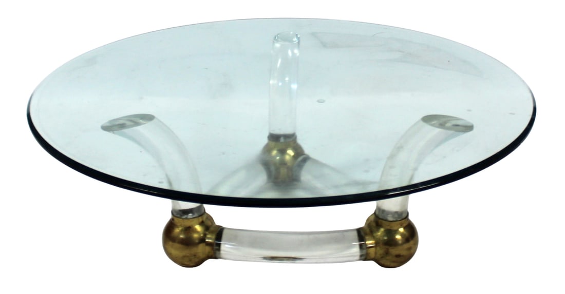 After Karl Springer Midcentury Lucite & Brass: Cocktail Table. Good looking table with heavy brass ball feet and thick Lucite frame. From a Syosset, Long Island estate. - Dimensions: 16" h x 48" d.