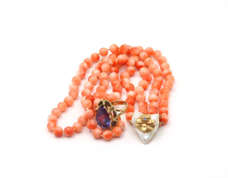 JEWELRY. 14kt Gold, Pearl, Coral, and Gem Necklace: A double-strand choker of individually knotted angel skin coral beads, featuring a detachable 14kt yellow gold clasp adorned with an affixed Baroque pearl and a 14kt yellow gold accent, highlighted by