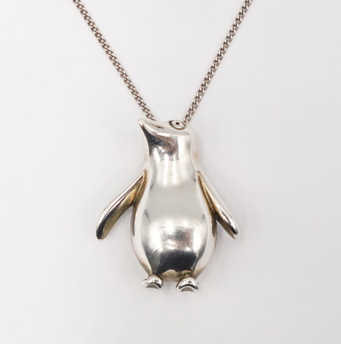 JEWELRY. Tiffany & Co. Sterling Penguin Pendant.: Tiffany & Co. sterling penguin pendant suspended from a Tiffany & Co. sterling chain necklace. Pendant is stamped verso, "© Tiffany & Co 925"; chain is inscribed, "Tiff