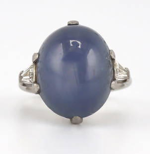 JEWELRY. GIA Natural Ceylon Star Sapphire Ring.: Antique platinum ring displaying a central prong-set oval star sapphire cabochon flanked by tapered diamond baguettes. Accompanied by an April 1st, 2025 Sapphire Origin Report no. 523538117 stating th
