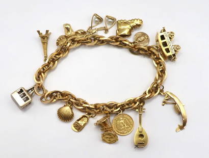 JEWELRY. 18kt Gold Bracelet with Assorted Gold and: Silver Charms. An Italian 18kt yellow gold link bracelet - stamped "750" alongside an Italian national mark, suspending (1) .800 silver cable car charm - stamped "800"; (1) unmarke
