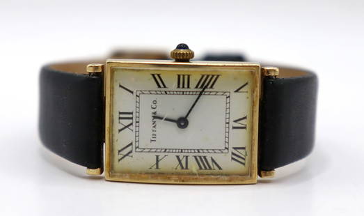 JEWELRY. Tiffany &amp; Co. 14kt Gold Tankard Watch.: An engraved vintage Tiffany &amp; Co. 14kt gold mechanical tank-style watch. This watch by Tiffany &amp; Co. features an approximately 21mm (excluding crown) 14kt yellow gold tank-style case, engraved