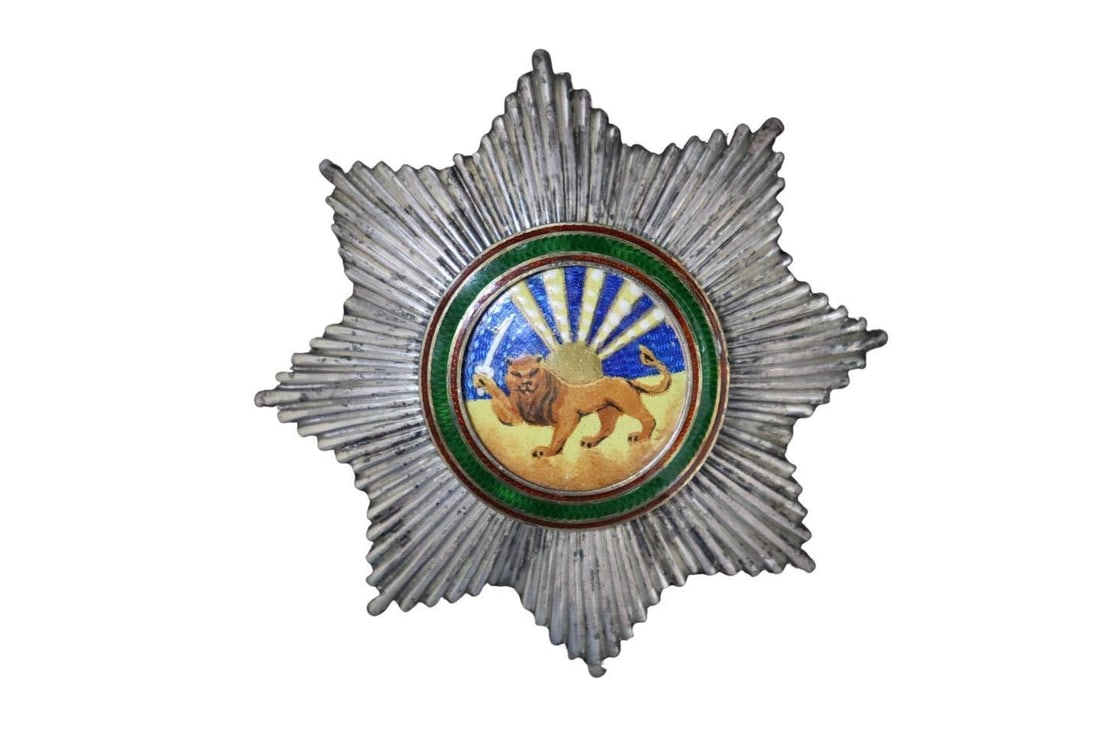 MILITARIA Order of Humayoun 800 Silver Breast Star: A finely crafted Persian Order of Humayoun (Nishan-i-Humayun) breast star, rendered in .800 silver. The eight-pointed star features ribbed rays and a central enameled medallion depicting a standing li