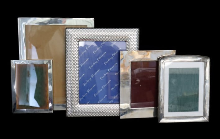 STERLING. (5) Assorted Sterling Picture Frames.: Including (1) sterling frame with a felt lined easel back – stamped, "Sterling", measuring approx. 4" x 6"; (1) English silver mounted frame with a wood easel back, measuring