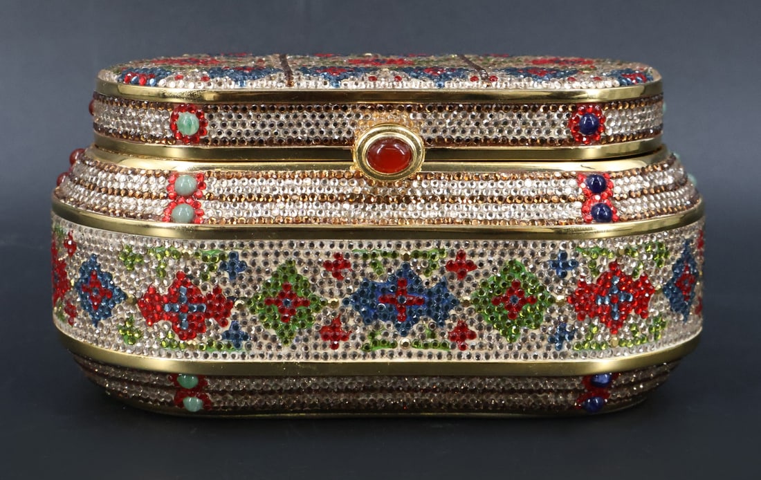 COUTURE. Judith Leiber Crystal Minaudiere.: A hardshell gold tone Judith Leiber minaudiere displaying floral motifs. Edition of 8/50. Accompanied by the original box, dust bag, tasseled comb, mirror, and coin purse. From a Manhattan, NY estate.