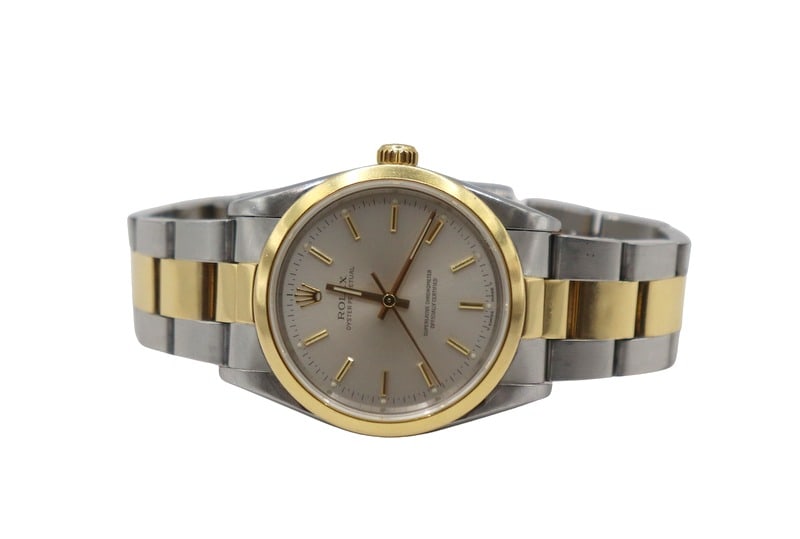 JEWELRY. Vintage Rolex Oyster Perpetual Two-tone: Watch. A men's vintage Oyster Perpetual stainless steel and 18kt yellow gold watch, Ref. #14203, with an Oyster bracelet. This Rolex, manufactured in 1989 (based on the serial number: L725086), featur