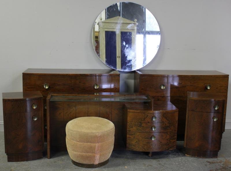 Herman Miller Midcentury Rosewood Bedroom Set.: Designed by Gilbert Rhode? Includes 2 bowfront chests, two nightstands, a vanity, mirror and ottoman. From a White Plains, NY home. Dimensions: Bowfront chests- 46" wide x 19" deep x 34" high; Nightst