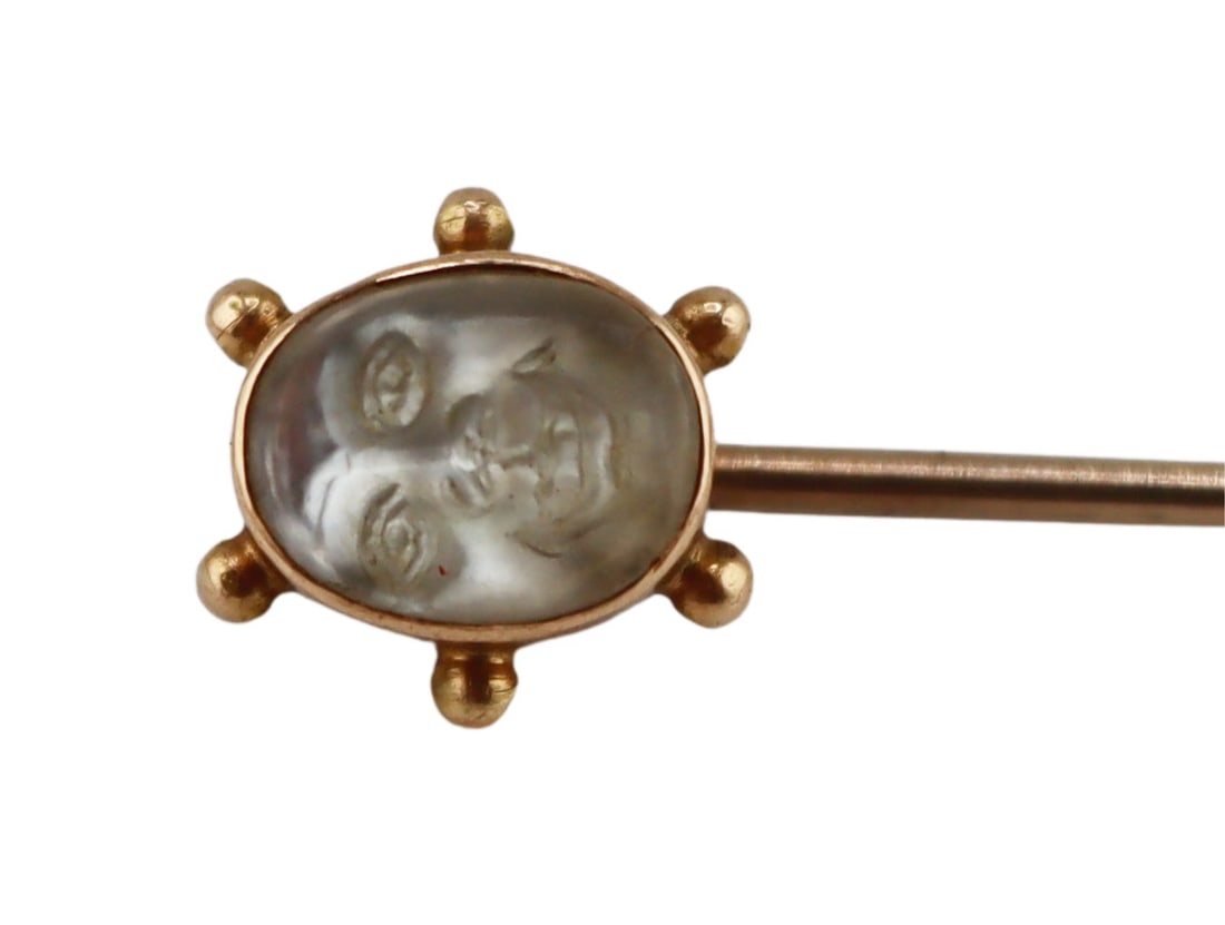 JEWELRY. 14kt Gold and Carved Moonstone Stickpin.: 14kt yellow gold stickpin displaying a bezel set moonstone carved face with beaded surround. Total approx. weight of the stickpin is 5.5mm x 7.5mm. From a Westchester, NY estate. Dimensions: stickpin