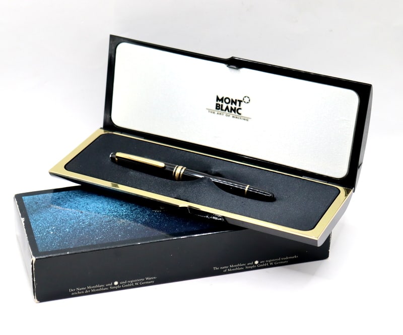 Montblanc Meisterstück Classique Fountain Pen.: A vintage W. German Montblanc Meisterstück Classique black resin body fountain pen with gold-tone accents and a 14kt gold nib. Accompanied by the outer box, hard clamshell box, papers, and a dust