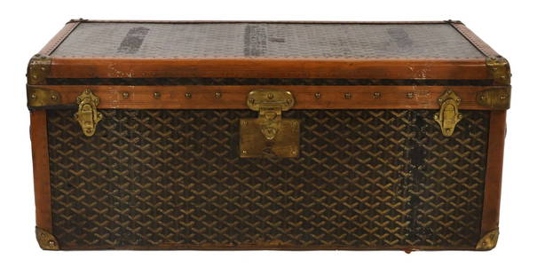 COUTURE. Vintage Goyard Trunk.: A Goyard leather and wood trunk in the brand's iconic hand painted print with an internal shelved compartment to the interior. The Goyard label is present on both sides of the trunk. From a Westcheste