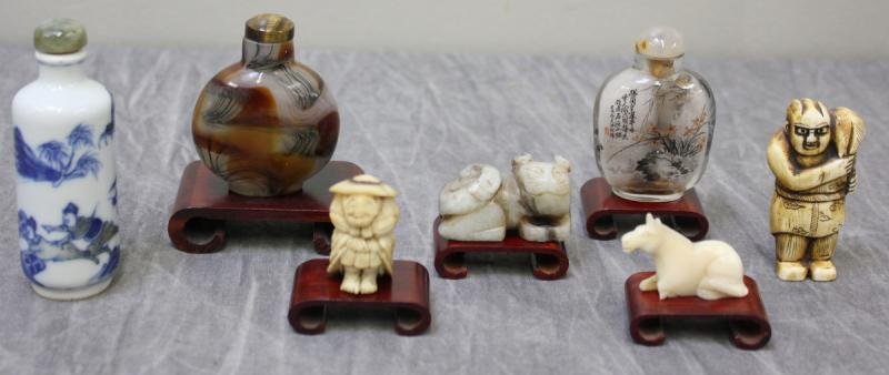 Asian Lot.: Includes 3 snuff bottles; a Netsuke figure of a man holding an animal; an ivory horse - as is missing one front leg; a hardstone cat; and a small ivory figure of seated man. Total of 7 items. From a N