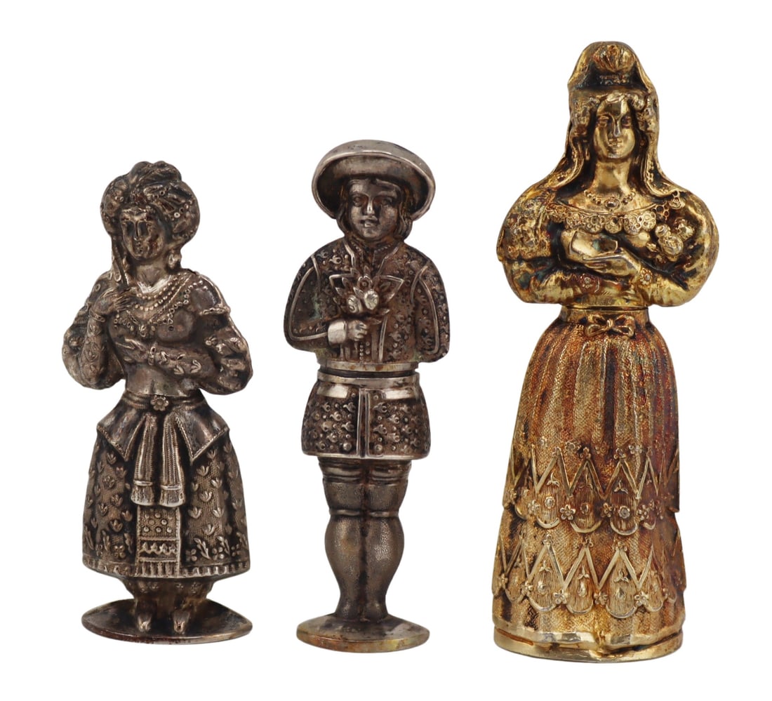 SILVER. (3) Wonderful Silver Figural Needle Cases.: Includes (2) antique, presumably French, .800 silver figural needle cases - one beautifully adorned Elizabethan standing lady who lifts at the waistline to reveal the needle case, and a well matched s