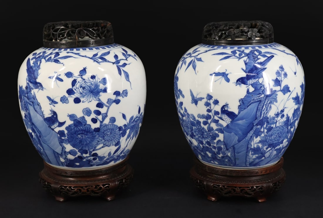 Pair of Chinese Blue and White Jars.: A pair of Chinese blue and white jars displaying birds and flowers with pierced wooden lids. Accompanied by wooden stands. From a White Plains, NY estate. Dimensions: jars measure approx. 8" h.