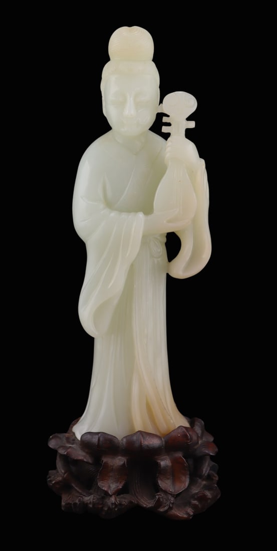 Chinese Carved Celadon Jade Beauty with Instrument: Chinese carved Celadon jade of a Meiren or beauty standing holding an instrument, possibly a pipa? Accompanied by a well executed carved lotus flower fitted base. Total approx. weight of the figure is