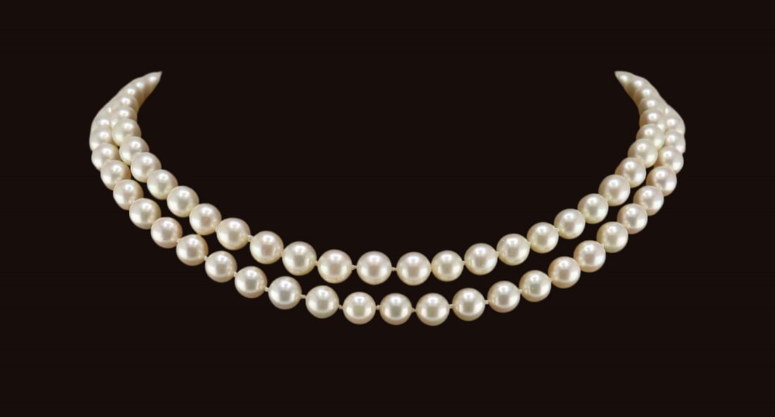 JEWELRY. Pearl, Sapphire and Diamond Necklace.: Individually knotted multi-strand pearl necklace with a 14kt yellow gold floral form clasp displaying a central cluster of (5) round faceted sapphires surround a single diamond accent. Pearls measure