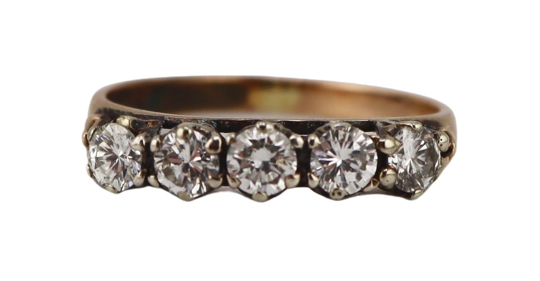 JEWELRY. 9kt Gold and Diamond Wedding Band Ring.: 9kt yellow gold wedding band ring displaying (5) prong-set round brilliant cut diamonds. Each diamond measures approx. 3.0mm each. With improper mark of "18K" to the interior of the band. To