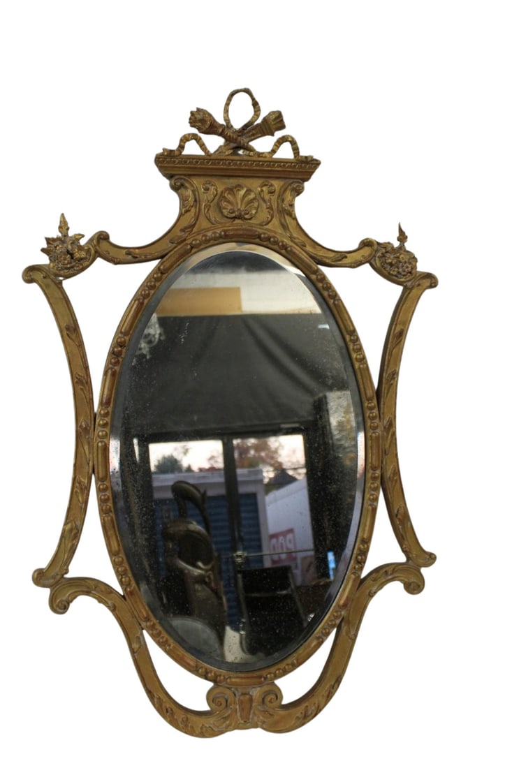 Vintage and Finely Carved Giltwood Mirror: Nice shaped mirror with arrow, ribbon and shell carving. From a Greenwich CT estate. - Dimensions: 45" x 28"