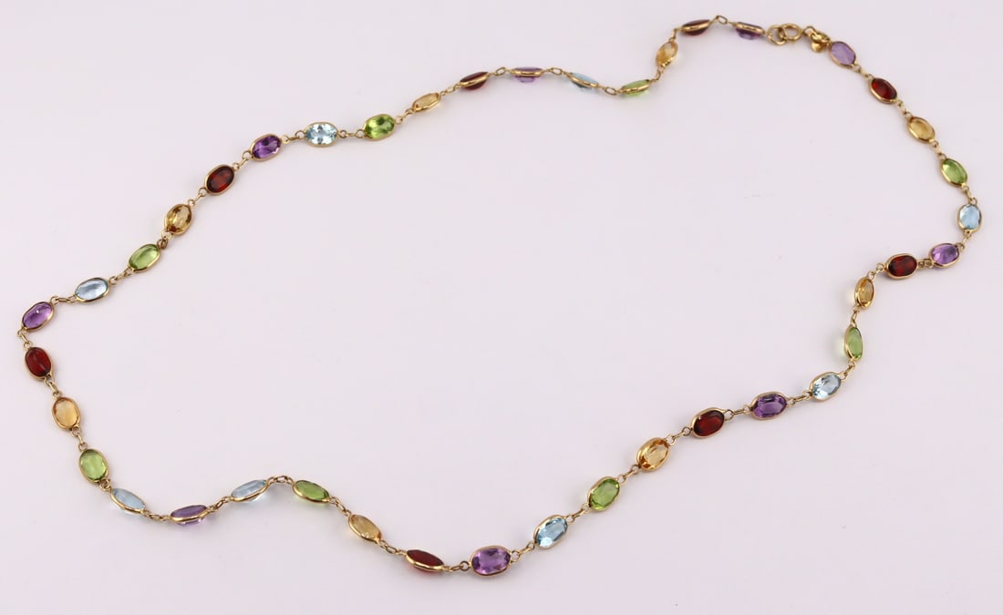 JEWELRY. ASH 14kt Gold and Colored Gem Necklace.: Signed ASH 14kt yellow gold necklace displaying (41) oval faceted colored gems in an array of colors. With (2) hang tags inscribed, "ASH" and, "14K". Total approx. weight of the ne