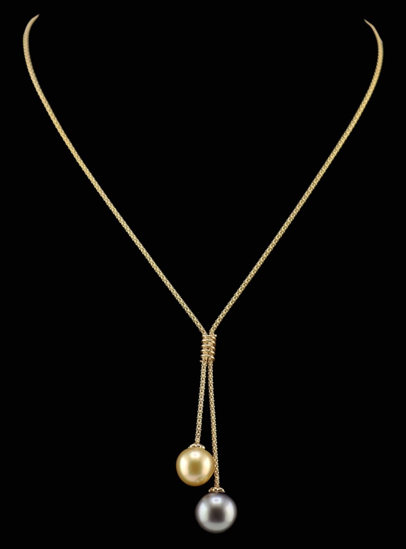 JEWELRY. Italian 14kt Gold and Pearl Necklace.: Italian 14kt yellow gold lavalier style necklace displaying a tiered drop pendant suspending a single round golden pearl and a single round Tahitian? pearl. Golden pearl measure approx. 12.0mm; Grey p