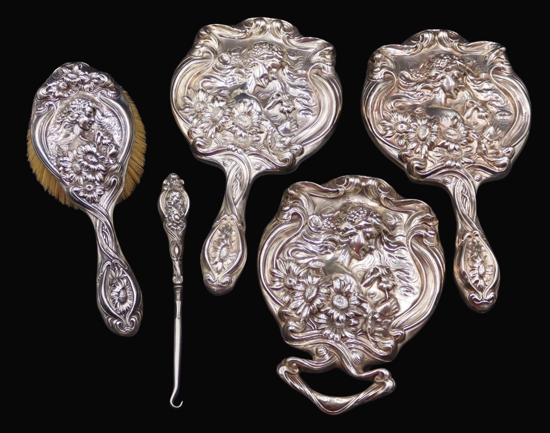 STERLING. 5 Pc. Unger Bros. Art Nouveau Sterling: Vanity Items. Unger Bros. Art Nouveau sterling vanity items includes (3) mirrors, (1) button hook, and (1) brooch all displaying high relief depictions of beauties with floral crowns, floral accents a