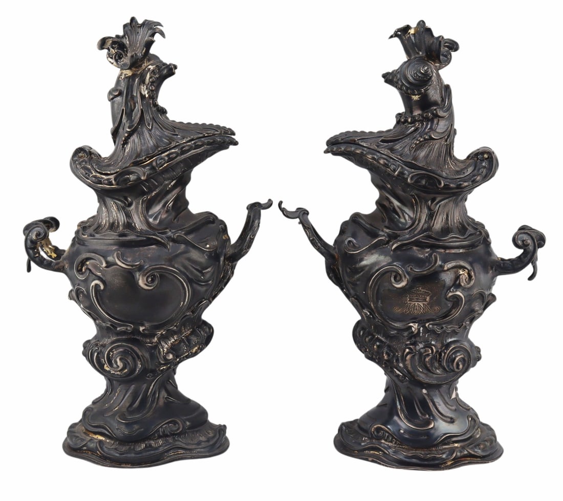 SILVER. Pair of George III? English Silver Ewers.: Pair of possibly George III Albartus Schurman English silver hinged ewers with ornate scroll decoration throughout and foliate and scroll handles. Stamped to the underside with London city stamps, mak