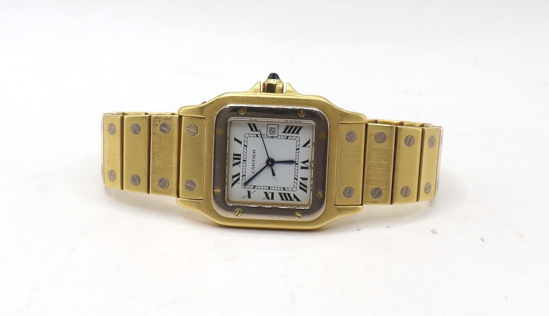 JEWELRY. Cartier Santos Carree Or Massif 18kt Gold: Watch. An exceptional Cartier Santos Carree "Or Massif" 18kt gold automatic watch with 18kt white gold accents. This watch by Cartier features a 29mm (excluding crown guard) 18kt yellow gold top-loadi
