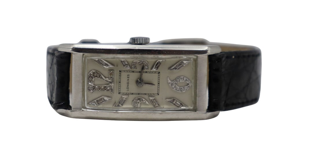 JEWELRY. Longines Curvex Platinum and Diamond: Watch. A vintage Longines Curvex platinum and diamond mechanical watch. This watch by Longines features a rectangular Curvex platinum 20mm watch case, glass crystal, silvered metal dial with applied d