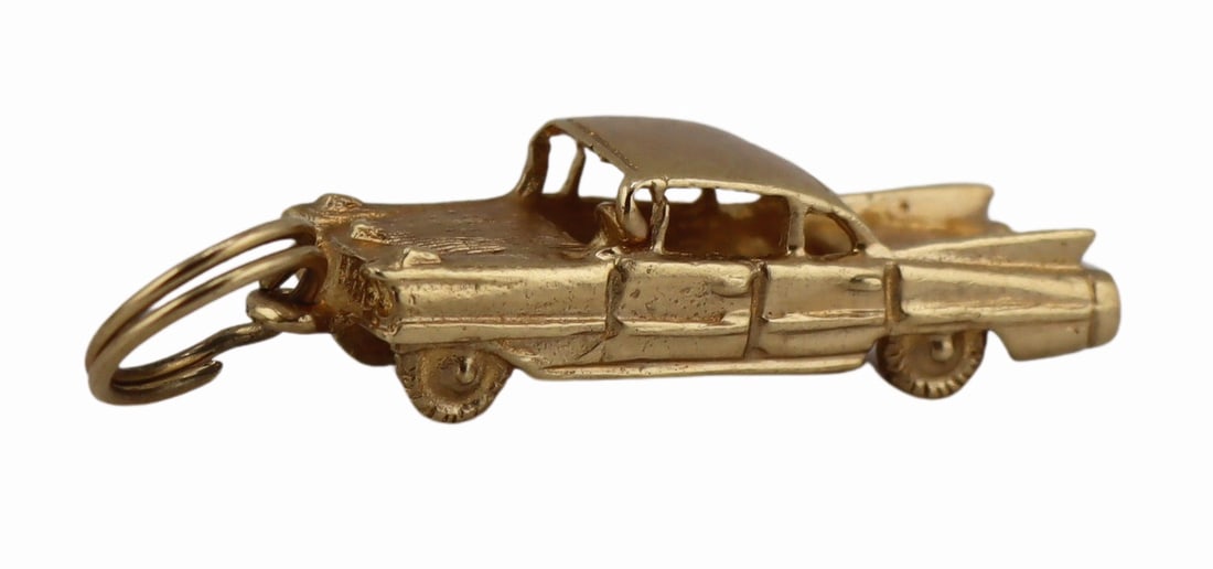 JEWELRY. Vintage 14kt Gold Cadillac Charm.: Vintage 14kt yellow gold Cadillac car charm. Stamped, "M&M 14K". Total approx. weight of the charm is 2.5 dwt (gross). From a New Rochelle, NY estate. Dimensions: charm measures approx. 