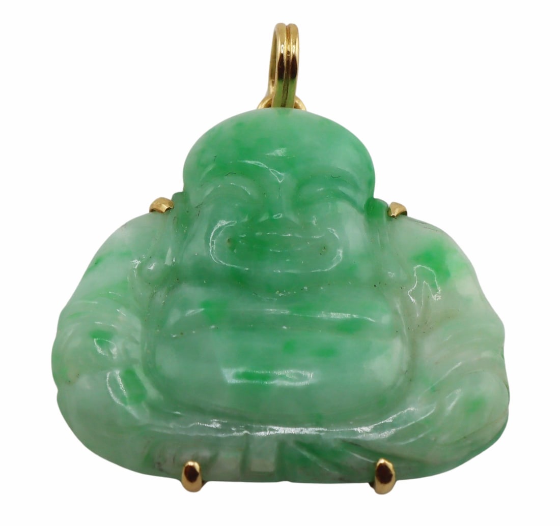 JEWELRY. TRIO 14kt Gold and Carved Jade Buddha: Pendant. TRIO 14kt yellow gold mounted carved jade pendant of a Buddha. Signed, "TRIO 14K" verso. Total approx. weight of the pendant is 15.5 grams (gross). From a Scarsdale, NY estate. Dime